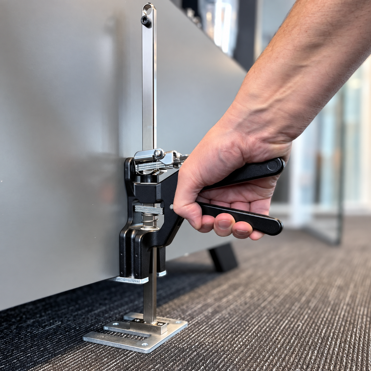 Hand lifting jack raising a cabinet off the floor during installation